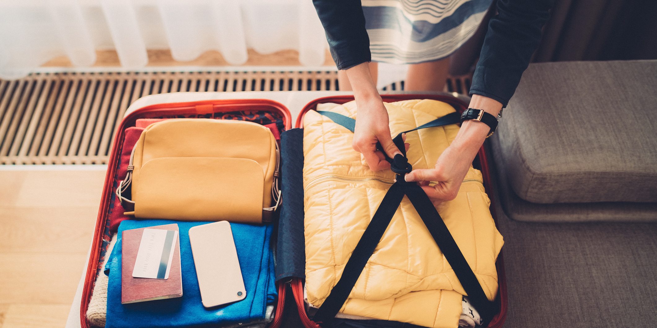 Tourist woman packing the suitcase before leaving